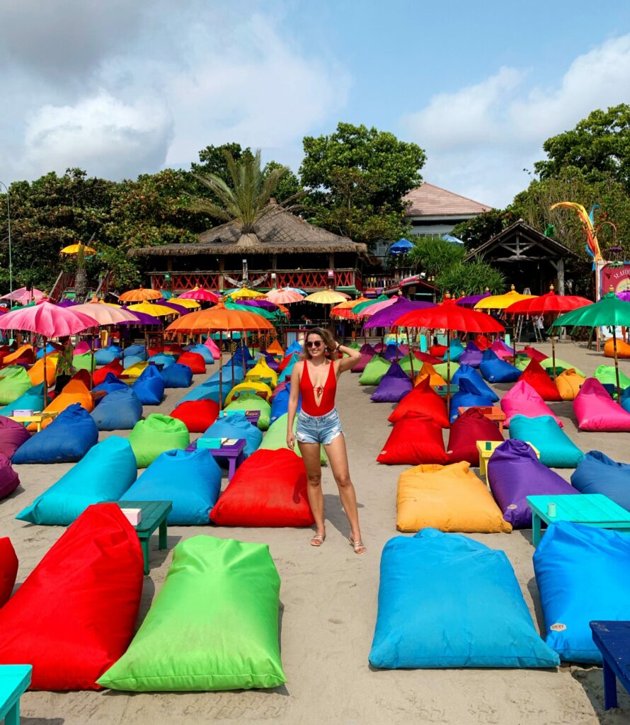 A girl stands in front of colorful beanbags at La Plancha, in Seminyak, Bali.
