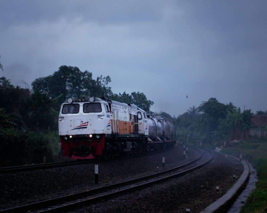 A train travels on the tracks through the fog in Java, Indonesia.
