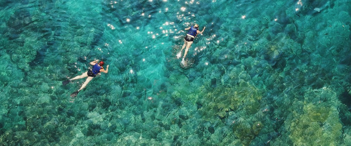 Three people snorkel near Nusa Penida Bali.